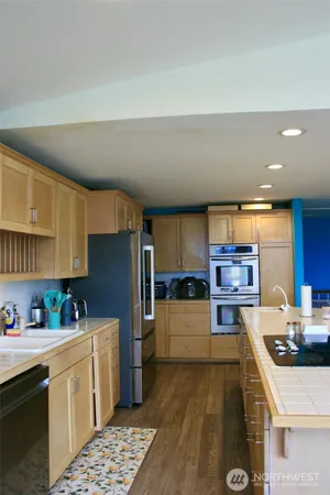 a kitchen with stainless steel appliances a refrigerator sink and stove