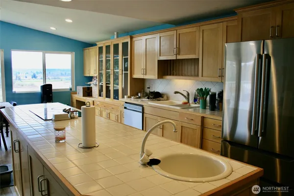 a kitchen with refrigerator and stove