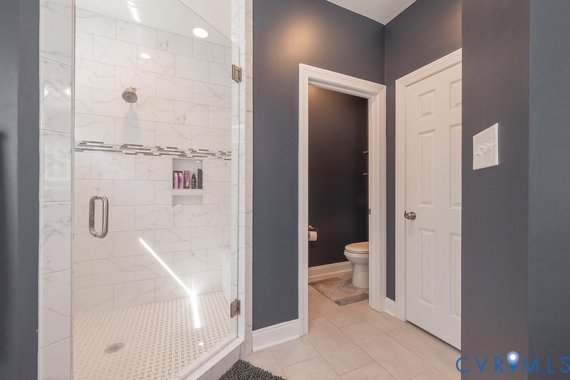 9425 Marie Road New Kent, VA 23124 - Photo 54 of 55 a bathroom with a glass shower door