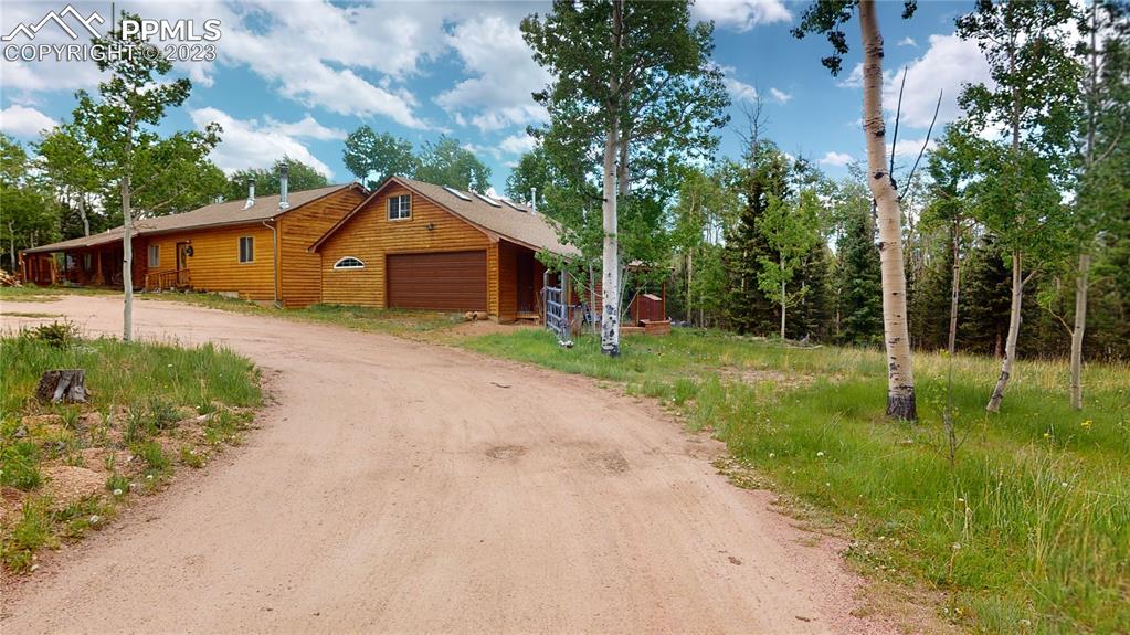 1011 Castle Ridge View Cripple Creek, CO 80813 - Photo 1 of 48 a front view of a house with yard