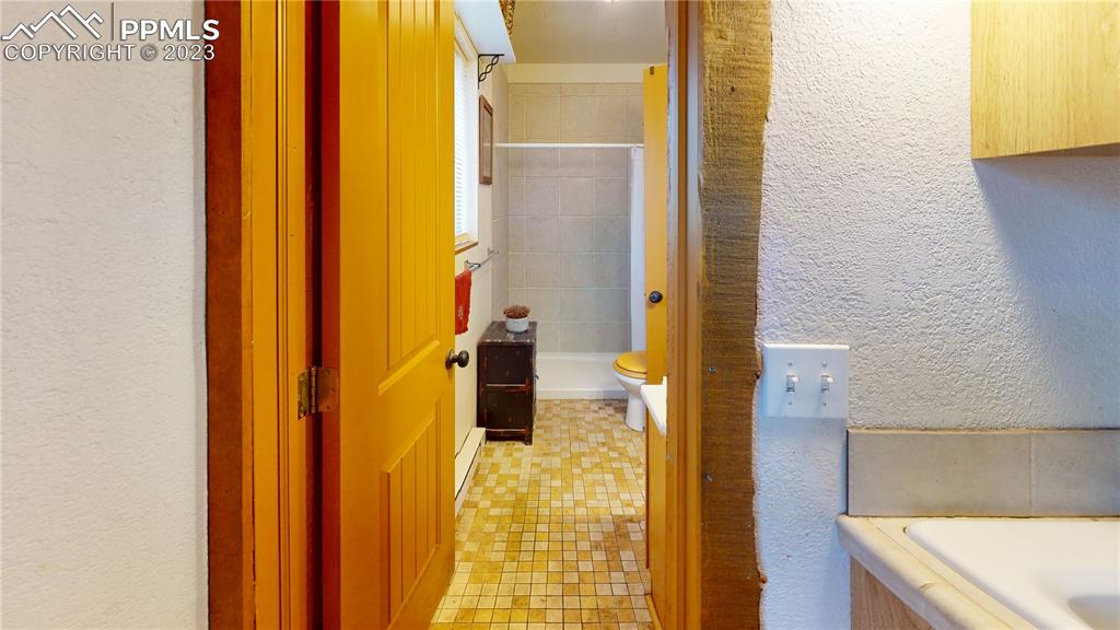 1011 Castle Ridge View Cripple Creek, CO 80813 - Photo 30 of 48 a bathroom with a bathtub and a shower