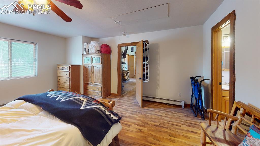 1011 Castle Ridge View Cripple Creek, CO 80813 - Photo 32 of 48 a bedroom with a bed and wooden floor