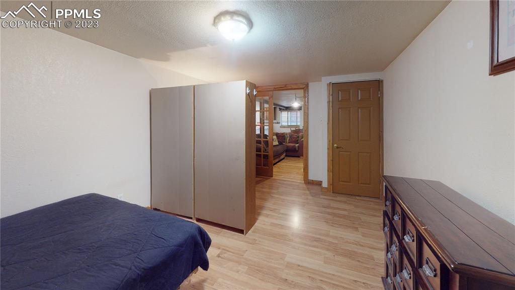 1011 Castle Ridge View Cripple Creek, CO 80813 - Photo 33 of 48 a bedroom with a bed and wooden floor