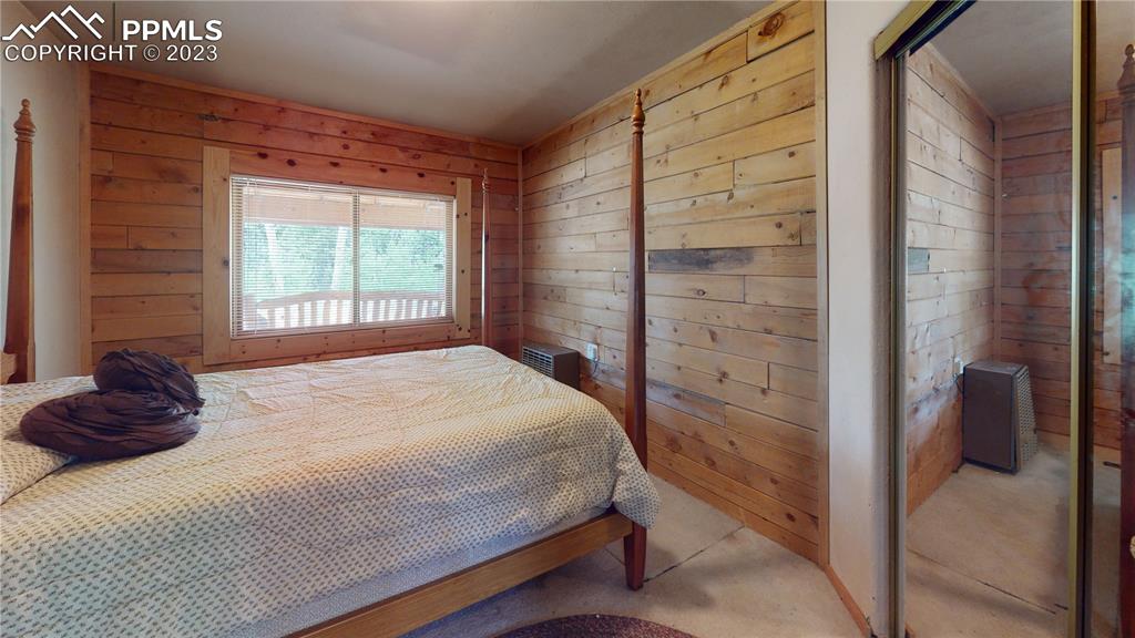 1011 Castle Ridge View Cripple Creek, CO 80813 - Photo 37 of 48 a bedroom with a bed and a window