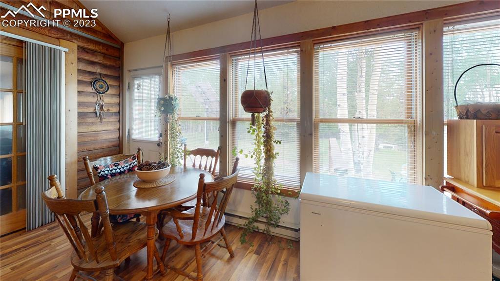 1011 Castle Ridge View Cripple Creek, CO 80813 - Photo 38 of 48 a view of a dining room with furniture and large windows