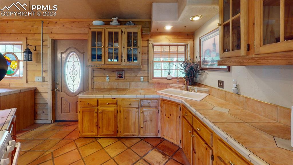 1011 Castle Ridge View Cripple Creek, CO 80813 - Photo 40 of 48 a kitchen with a sink a clock and cabinets