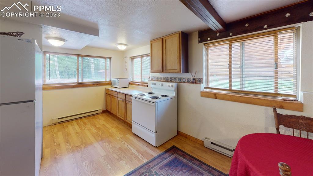 1011 Castle Ridge View Cripple Creek, CO 80813 - Photo 42 of 48 a kitchen with a sink wooden floor and a large window