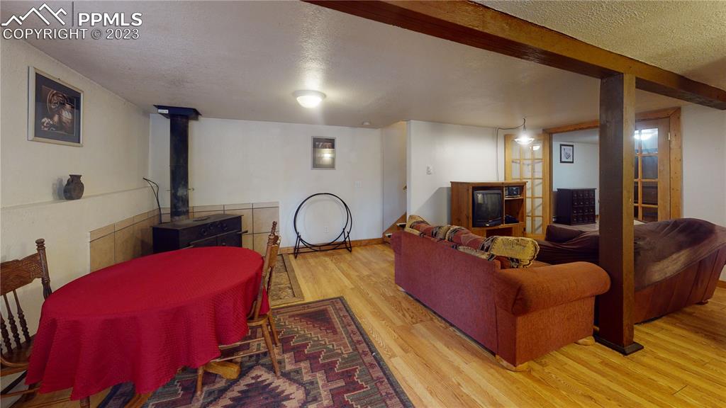 1011 Castle Ridge View Cripple Creek, CO 80813 - Photo 46 of 48 a living room with furniture a flat screen tv and a large window