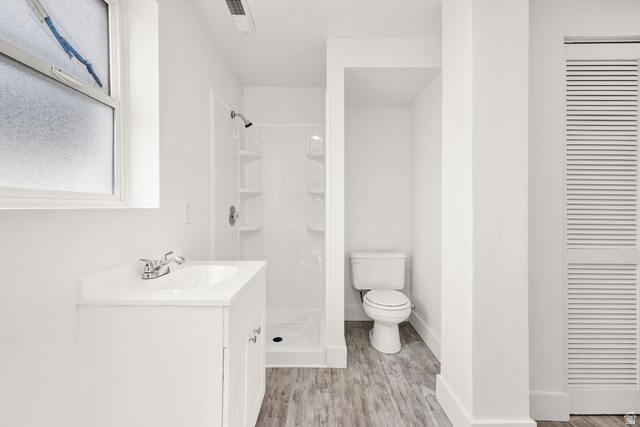 4155 Johnson Road Nibley, UT 84321 - Photo 36 of 71 Full bathroom featuring vanity, a shower stall, light wood finished floors, and a closet