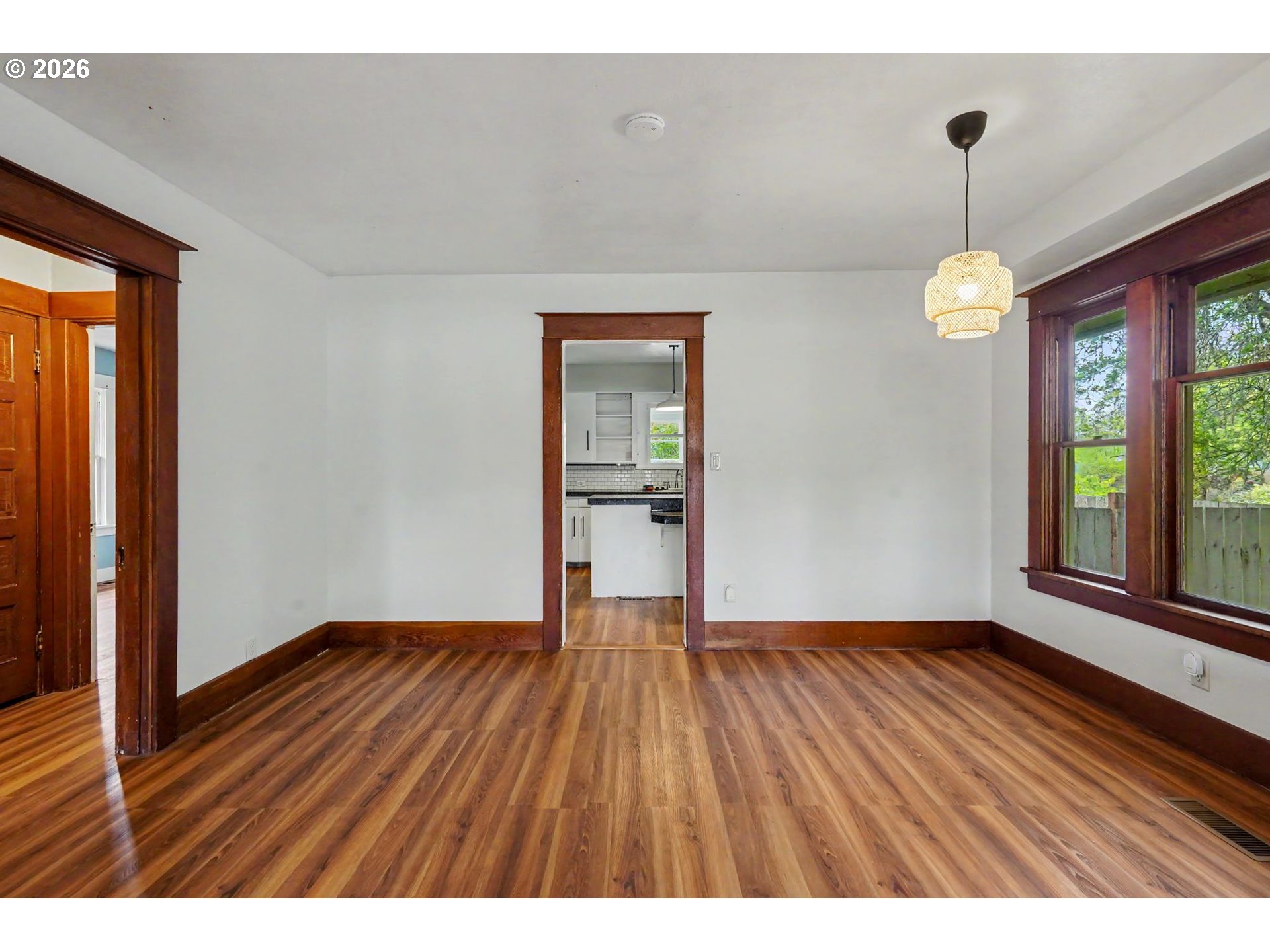 301 Orchard Street Silverton, OR 97381 - Photo 11 of 42 a view of an empty room with window and wooden floor