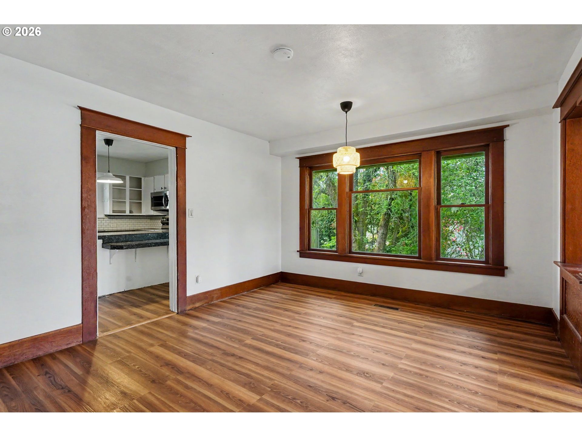 301 Orchard Street Silverton, OR 97381 - Photo 12 of 42 a view of an empty room with window and wooden floor