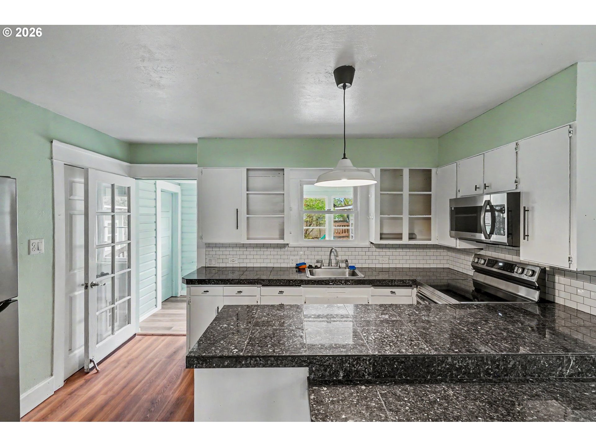 301 Orchard Street Silverton, OR 97381 - Photo 15 of 42 a kitchen with sink refrigerator and window
