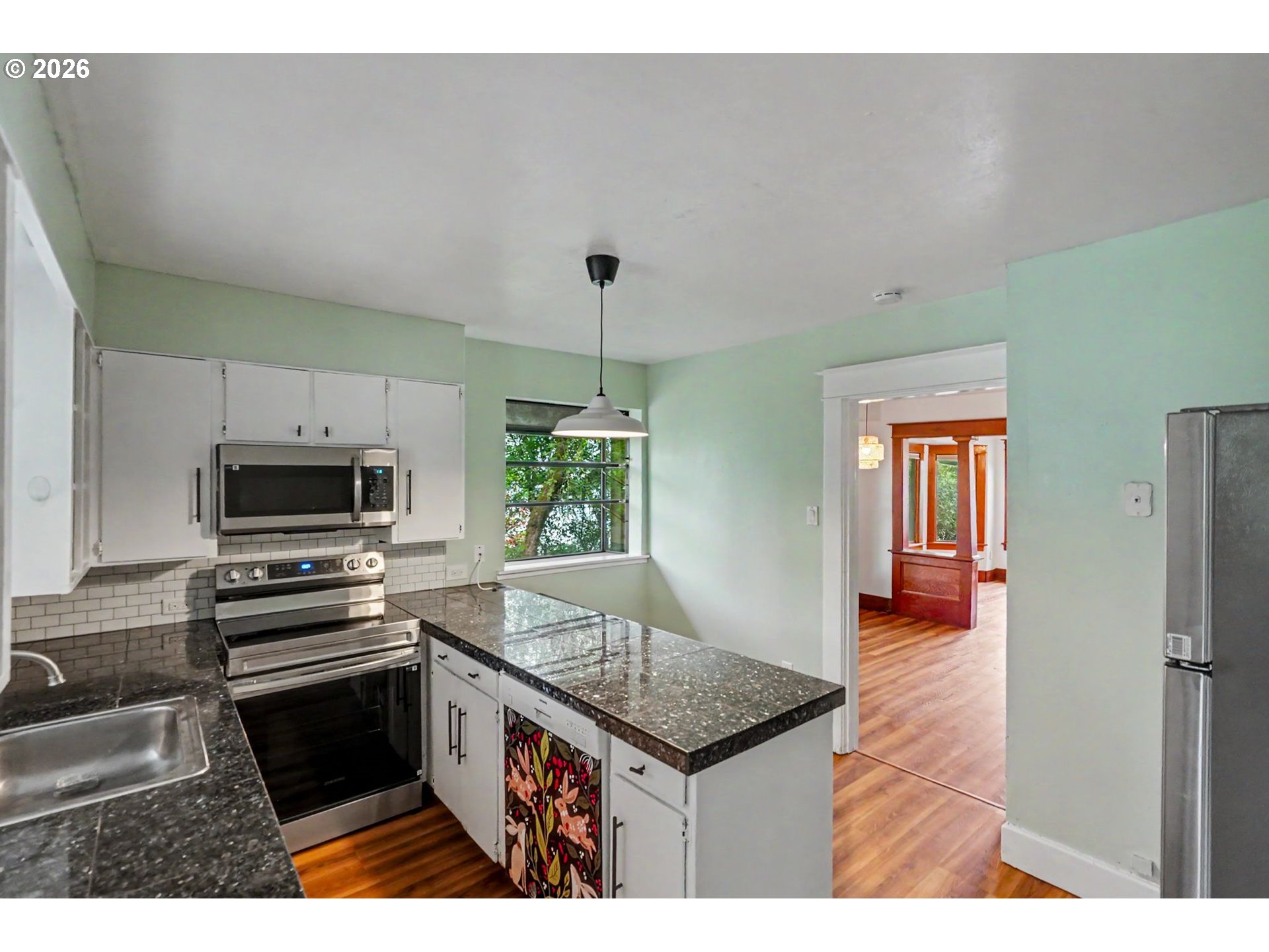 301 Orchard Street Silverton, OR 97381 - Photo 18 of 42 a kitchen with granite countertop a stove and a sink