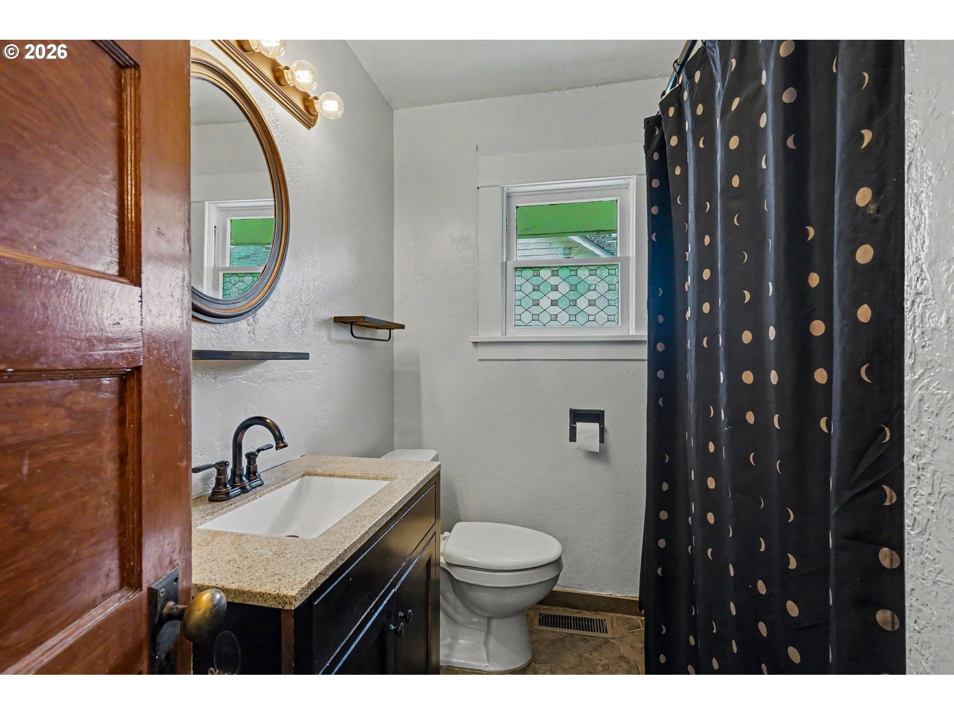 301 Orchard Street Silverton, OR 97381 - Photo 25 of 42 a bathroom with a sink a toilet and a mirror