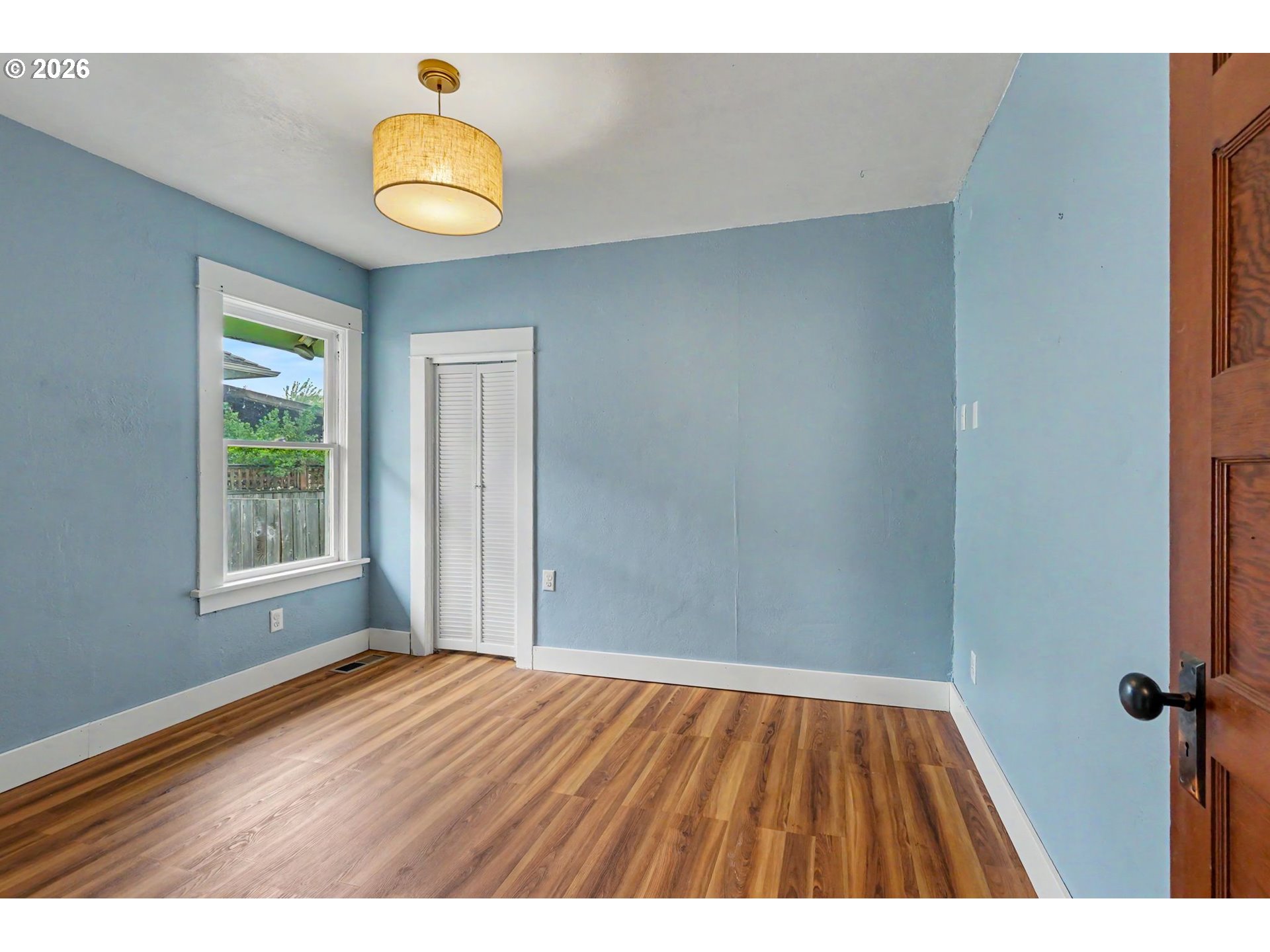 301 Orchard Street Silverton, OR 97381 - Photo 27 of 42 a view of an empty room with wooden floor and a window