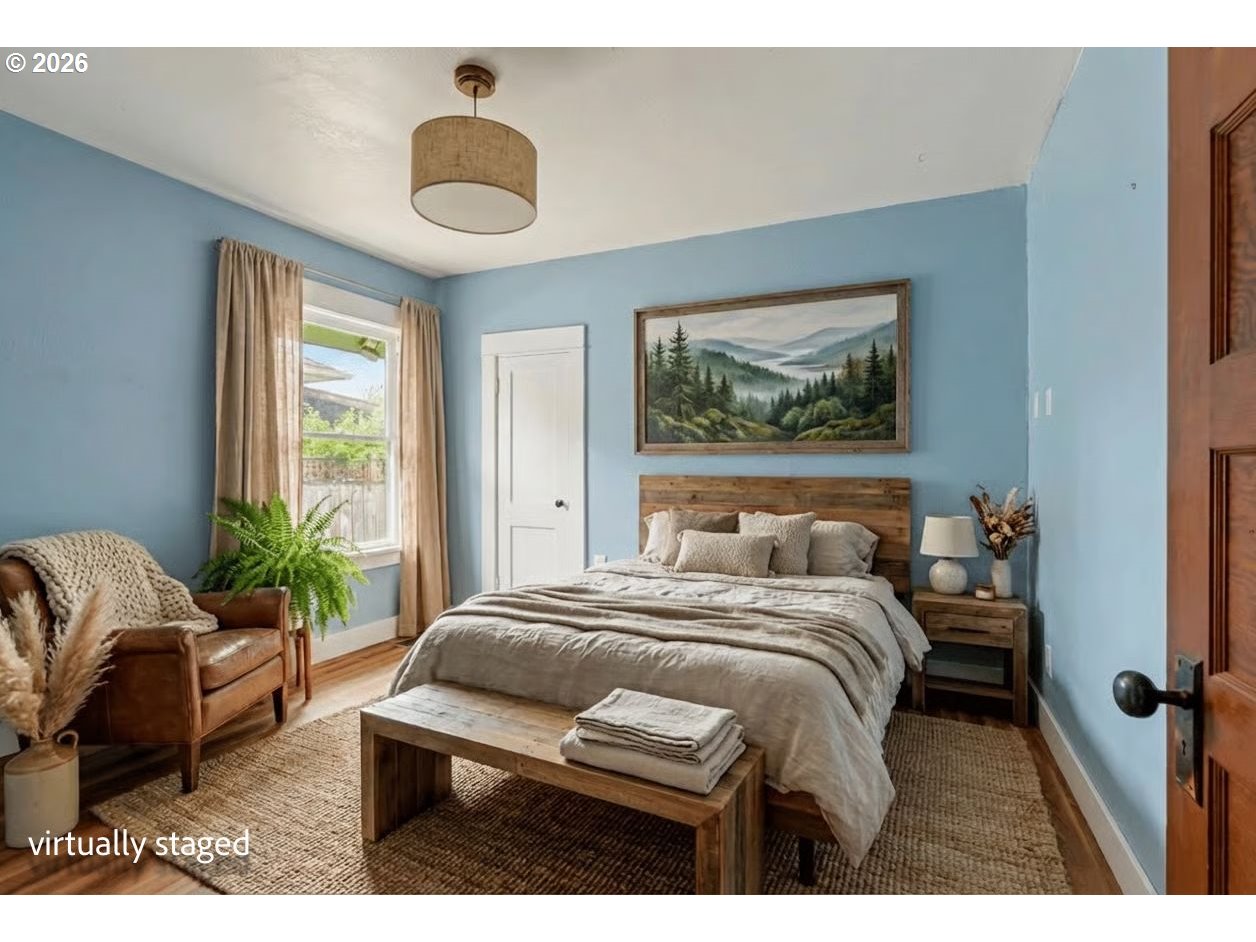 301 Orchard Street Silverton, OR 97381 - Photo 42 of 42 a bedroom with a bed and a chandelier