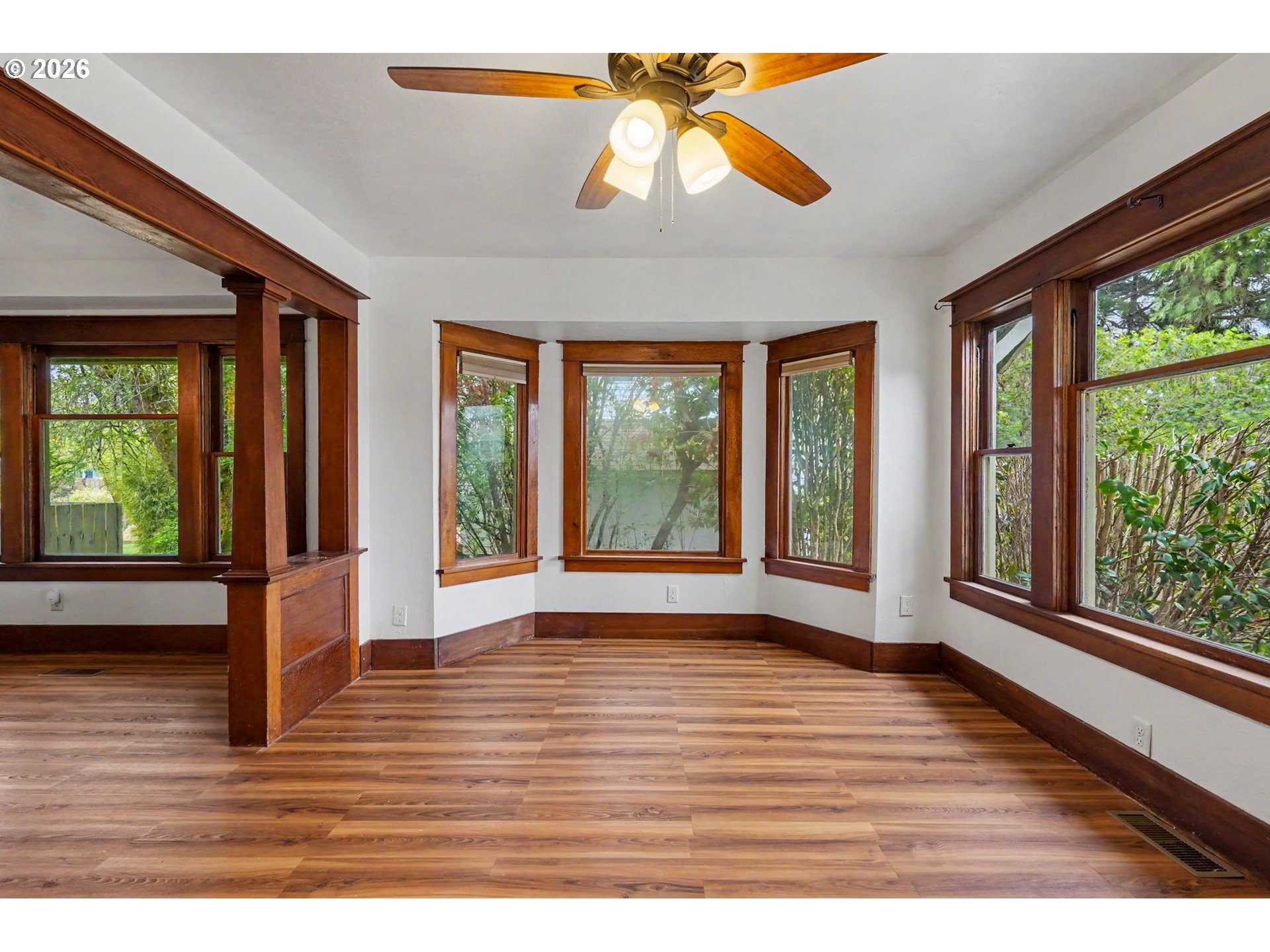 301 Orchard Street Silverton, OR 97381 - Photo 8 of 42 a view of an empty room with wooden floor and a window