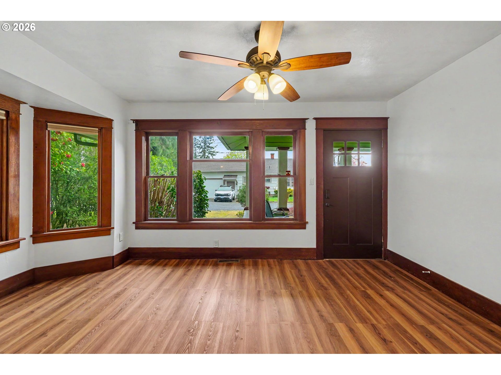 301 Orchard Street Silverton, OR 97381 - Photo 9 of 42 a view of an empty room with wooden floor and a window