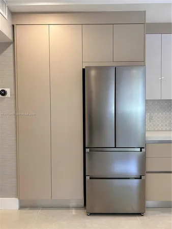 an empty room with closet and natural light