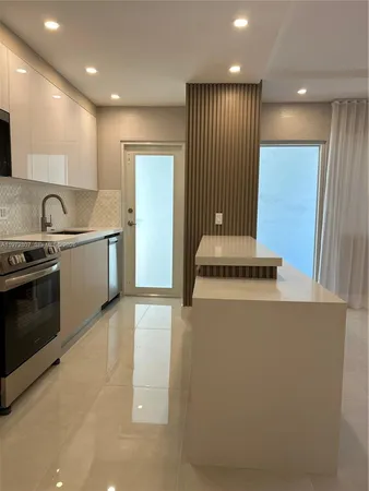 a stove top oven sitting inside of a kitchen