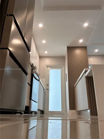 a view of a hallway with bathroom and shower