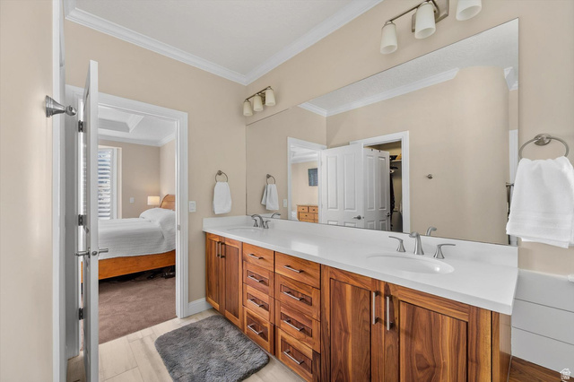 1456 Firelight Way Sandy, UT 84092 - Photo 7 of 22 Full bathroom featuring double vanity, connected bathroom, and ornamental molding