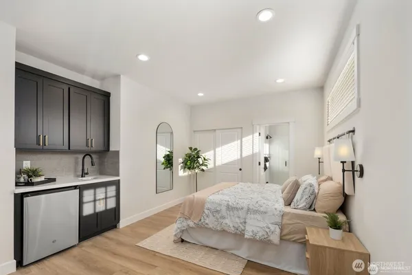 a spacious bedroom with a large bed and a chandelier