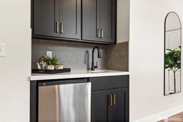 a kitchen with stainless steel appliances granite countertop a sink a microwave and cabinets