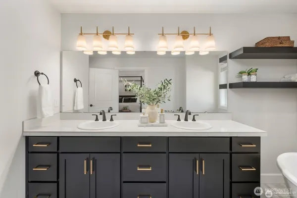 a bathroom with a sink vanity and a mirror