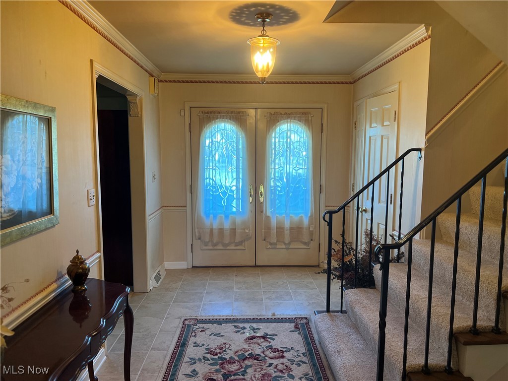3330 Stanley Road Akron, OH 44333 - Photo 4 of 22 Tiled entryway featuring crown molding and french doors