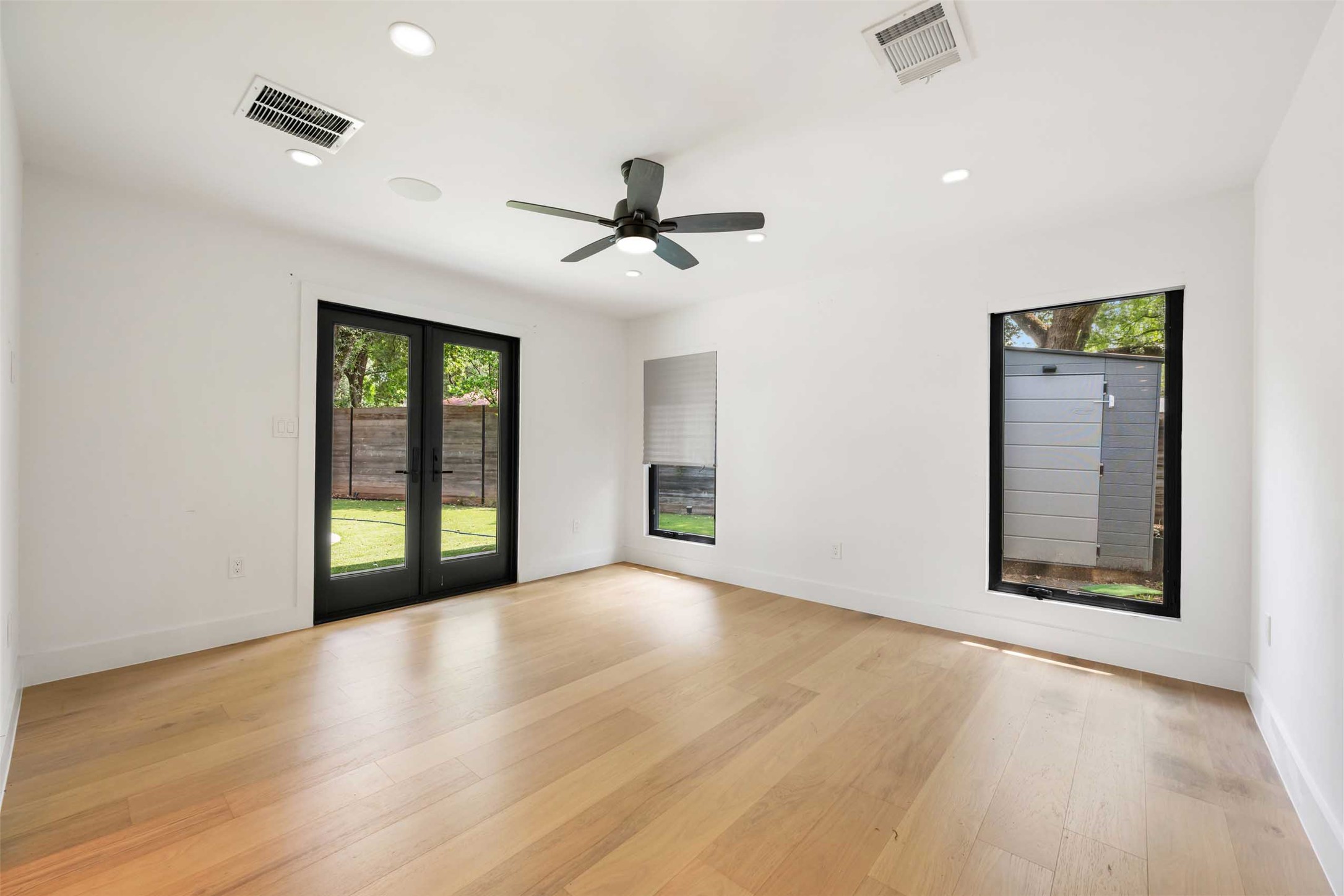 8900 Point W Drive Austin, TX 78759 - Photo 21 of 40 Hardwood floors and generous natural light create an inviting atmosphere in this versatile room.