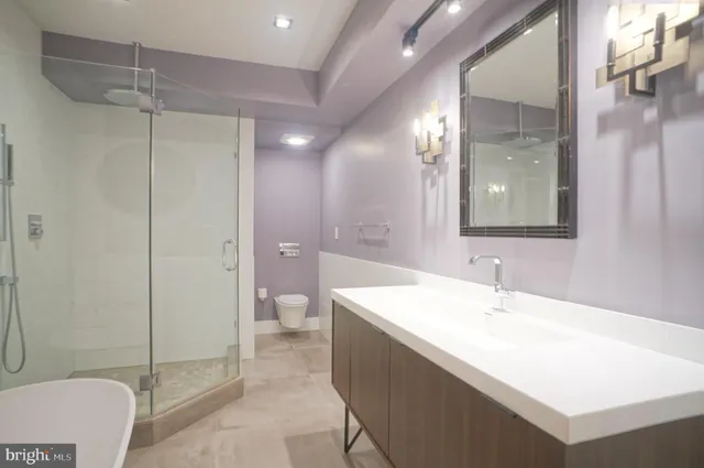 a bathroom with a tub sink mirror and a shower