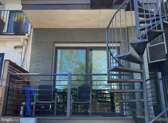 a view of front door and wooden staircase
