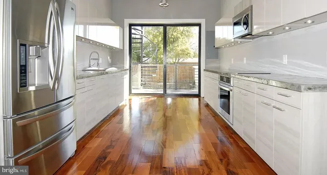 a view of a kitchen with a stove top oven