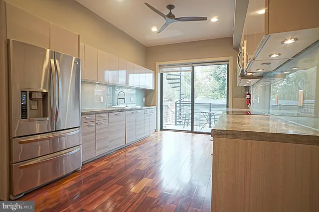 a kitchen with stainless steel appliances a refrigerator sink and microwave