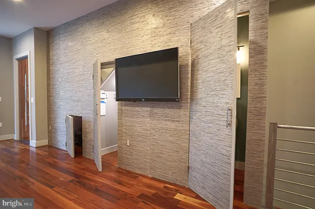 a bathroom with a shower and a flat screen tv