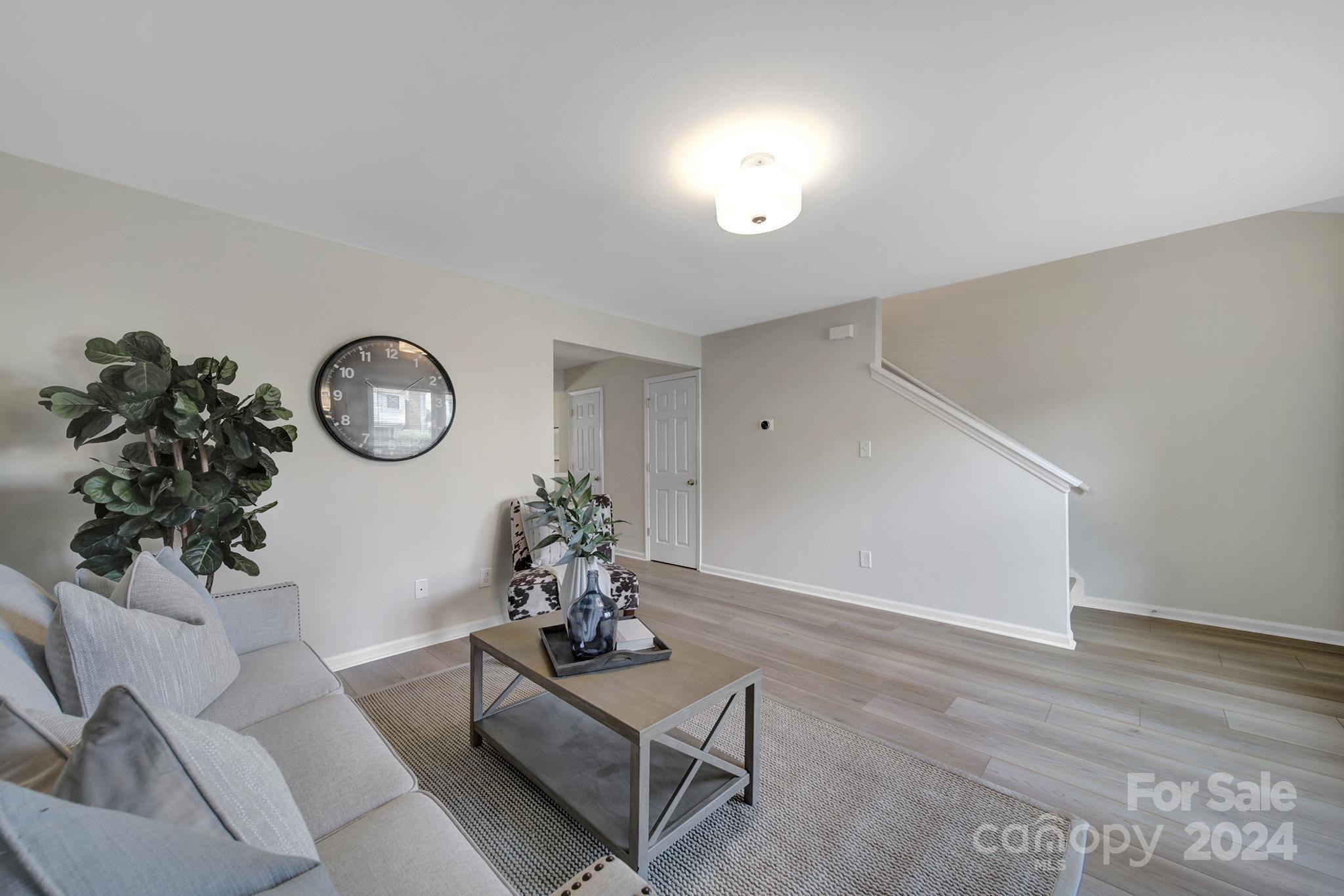 10943 Carmel Crossing Road Charlotte, NC 28226 - Photo 12 of 28 a view of a livingroom with furniture and a chandelier