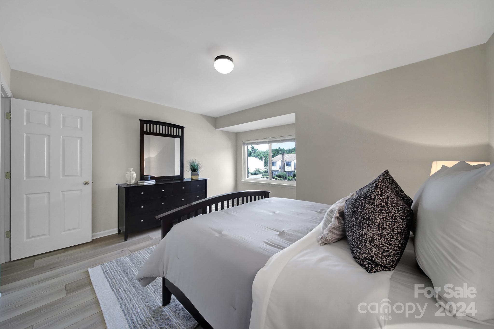 10943 Carmel Crossing Road Charlotte, NC 28226 - Photo 17 of 28 a bedroom with a bed window and dresser