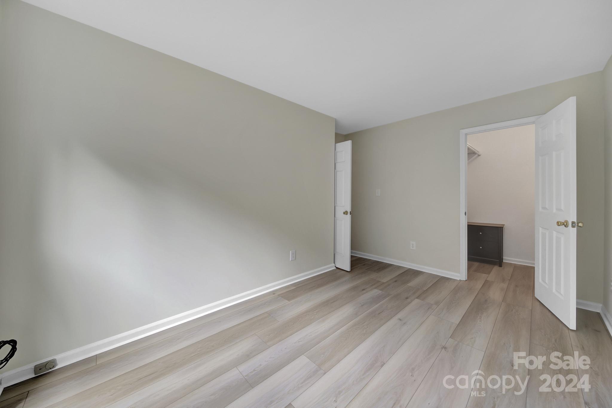 10943 Carmel Crossing Road Charlotte, NC 28226 - Photo 20 of 28 a view of an empty room with wooden floor