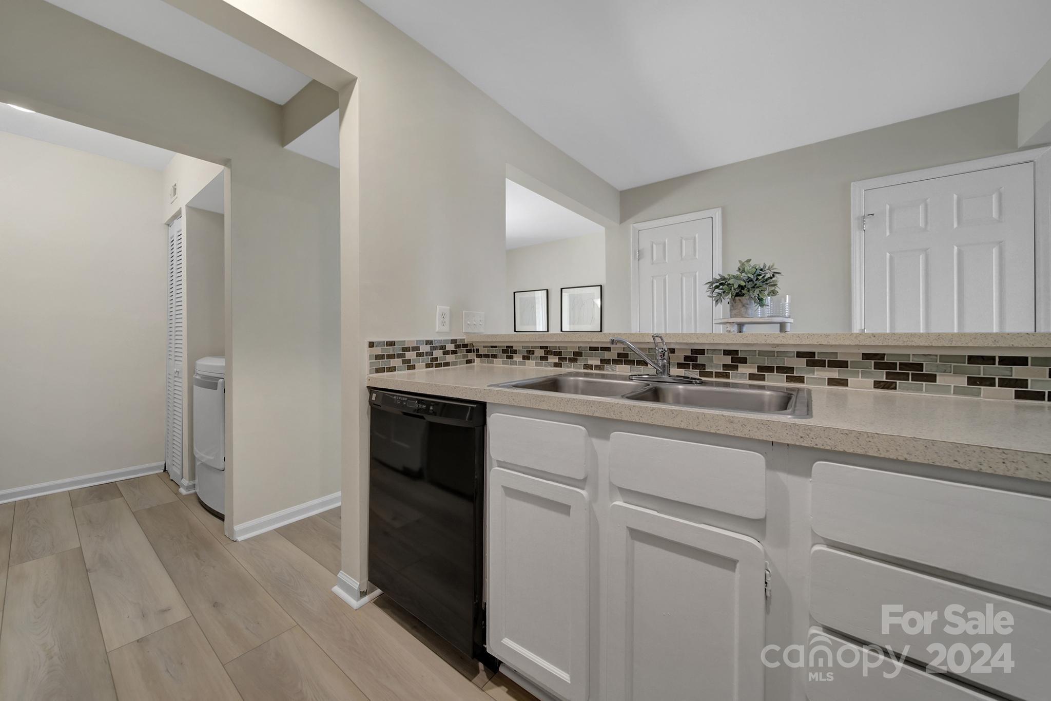 10943 Carmel Crossing Road Charlotte, NC 28226 - Photo 8 of 28 a kitchen with a sink and cabinets