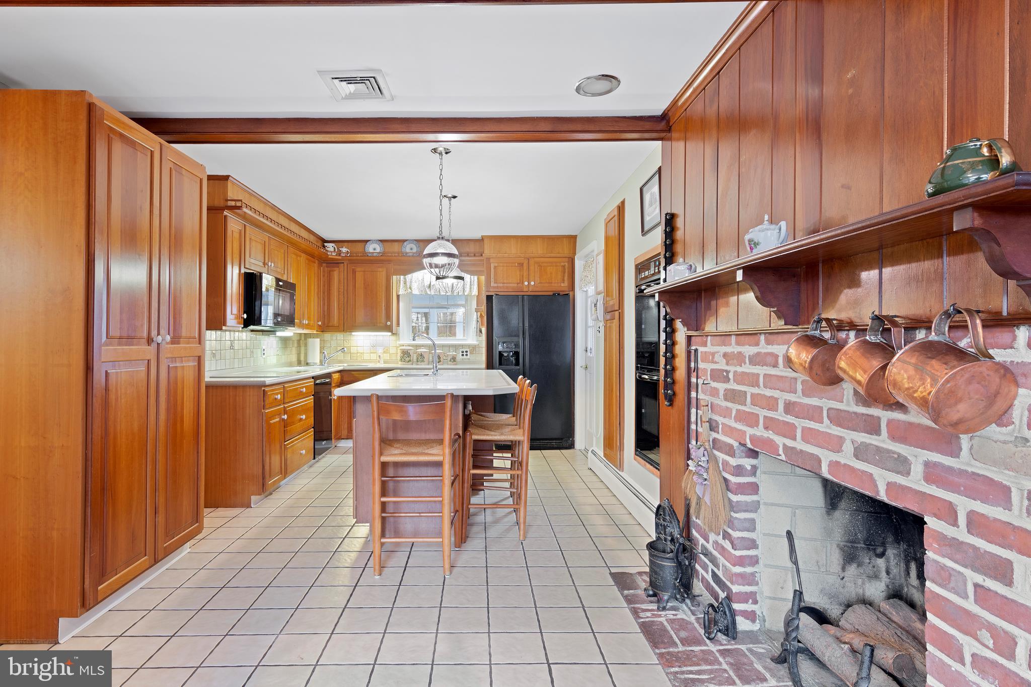 1831 Kimberwick Road Media, PA 19063 - Photo 16 of 36 Kitchen with tile floor & fireplace.