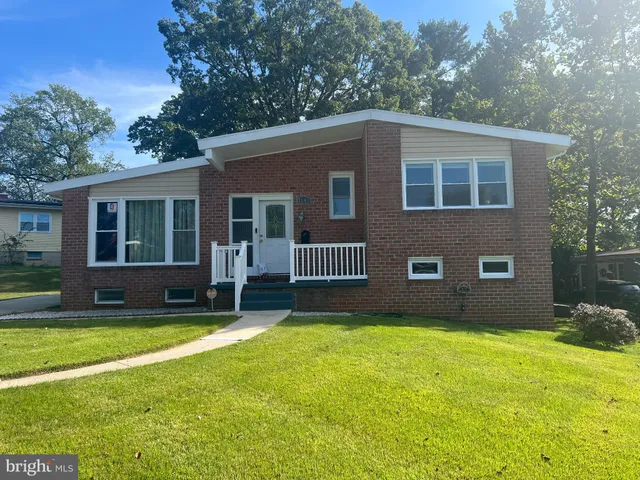 a house that has a big yard with wooden fence