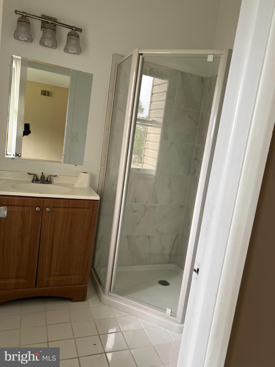 8503 Stevenswood Road Windsor Mill, MD 21244 - Photo 15 of 18 a bathroom with a sink a mirror and a shower