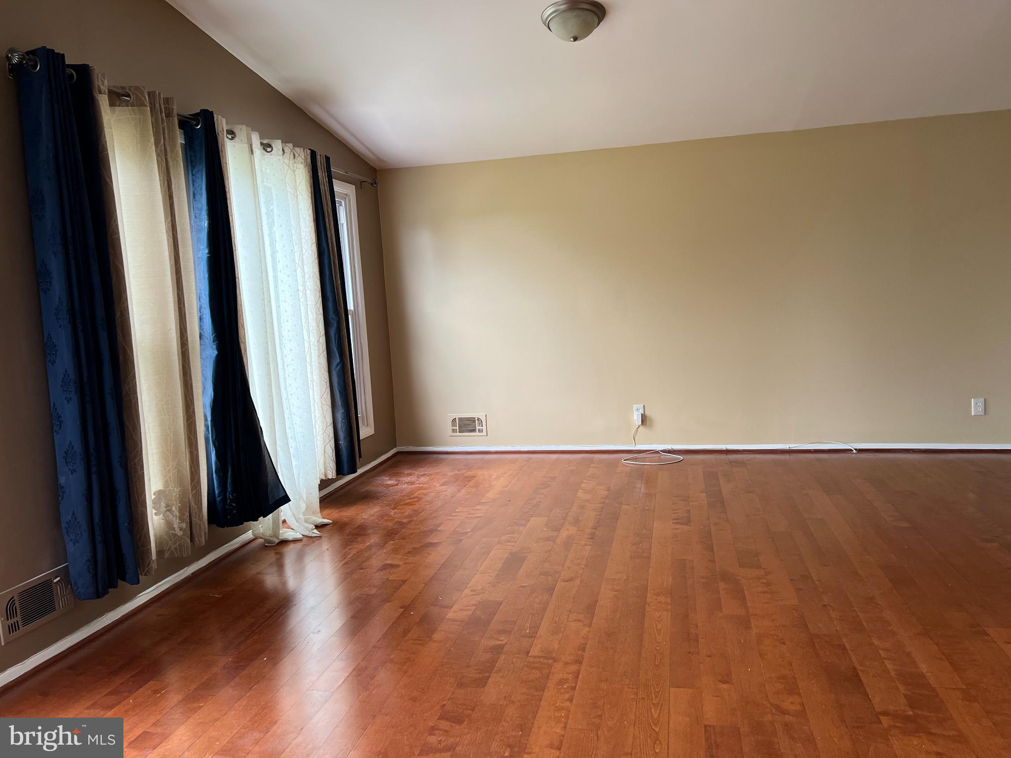 8503 Stevenswood Road Windsor Mill, MD 21244 - Photo 9 of 18 an empty room with wooden floor and a window