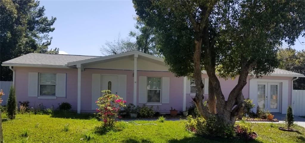 3794 Southwest 147 Lane Road Ocala, FL 34473 - Photo 1 of 1 a front view of a house with garden