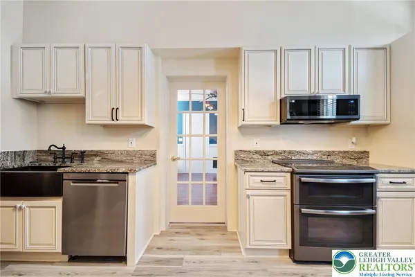 a kitchen with stainless steel appliances granite countertop a stove and a microwave