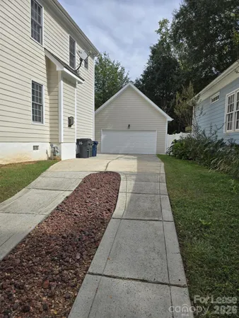 a view of backyard of house along with green space