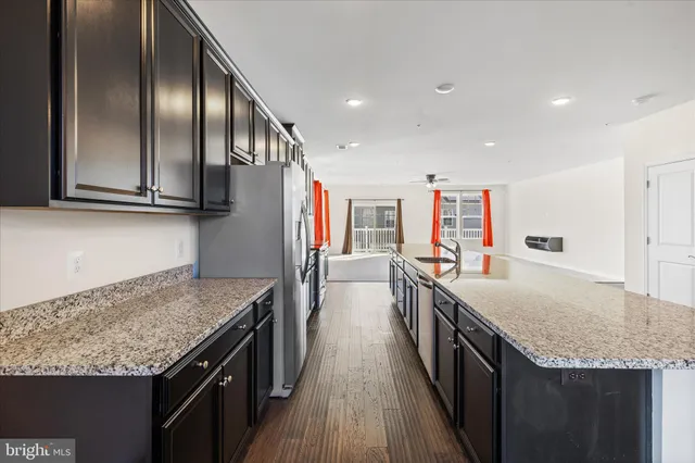 a kitchen with stainless steel appliances granite countertop a sink and stove