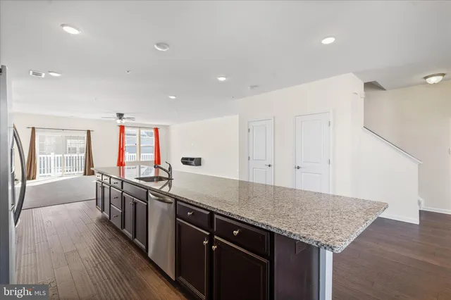 a kitchen with stainless steel appliances granite countertop a stove and a sink