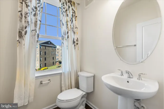 a bathroom with a sink toilet and a mirror